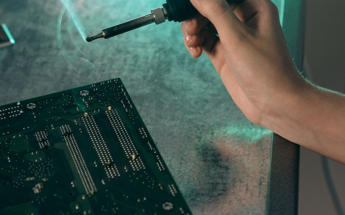 Close-up of soldering repair on a television board